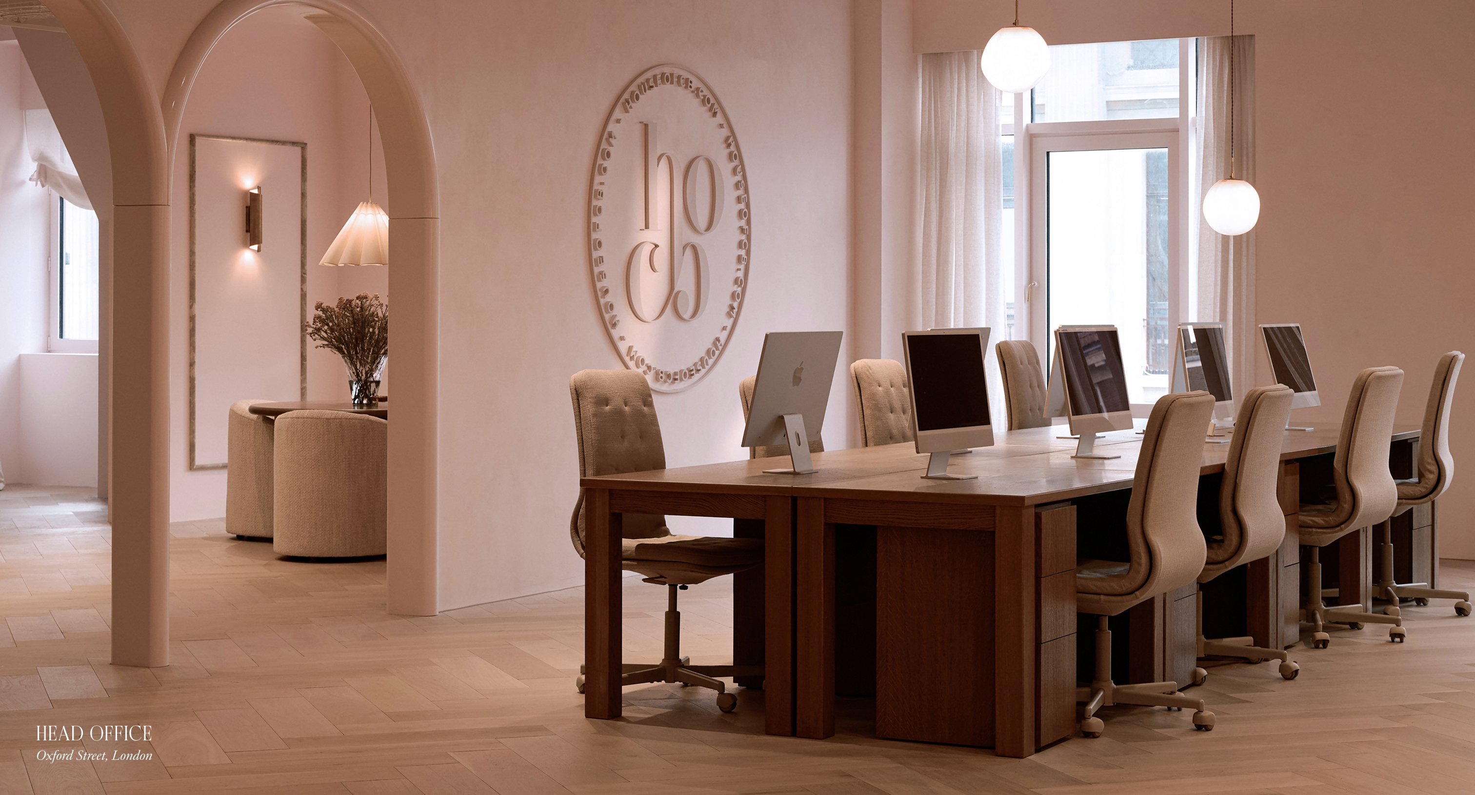 House of CB head office, Oxford Street, London — iMac workstations beneath the embossed brand seal